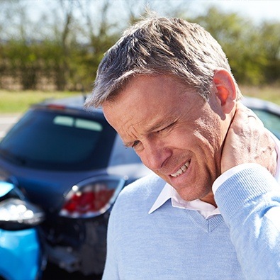 Man in pain holding neck