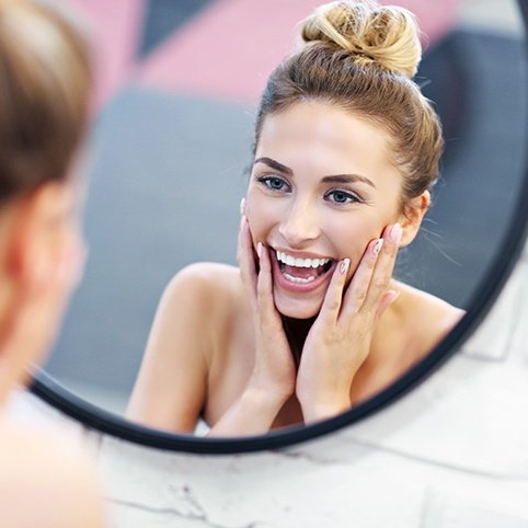 Woman examining smooth skin in mirror