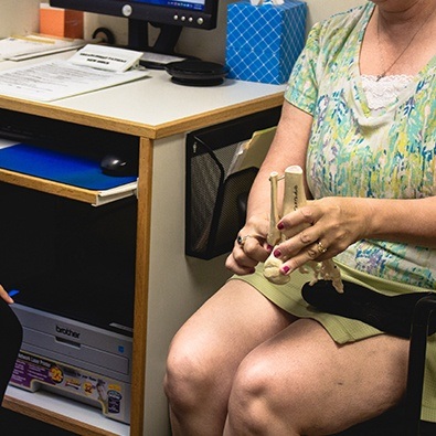Patient holding an ankle model