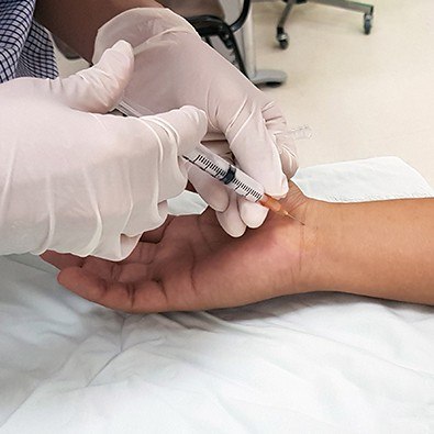 Patient receiving injection in wrist