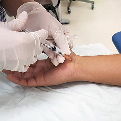 Doctor injecting patient's wrist