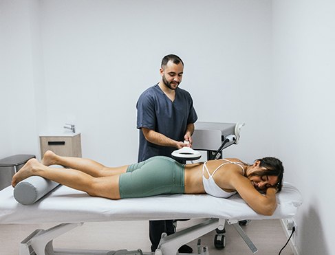 Woman undergoing extracorporeal magnetotransduction therapy