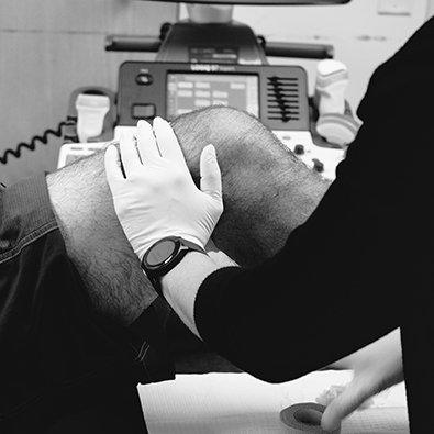 Doctor examining patient's knee
