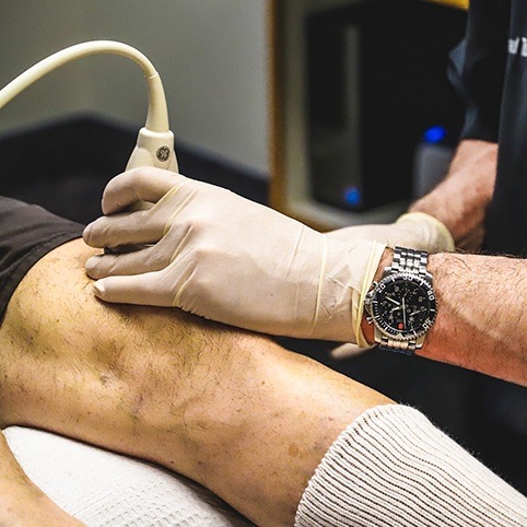 Doctor treating patient's knee