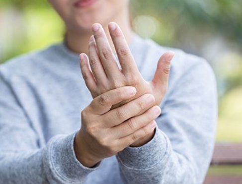 Woman in pain holding her hand