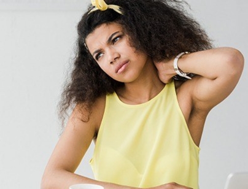 Woman in pain holding neck