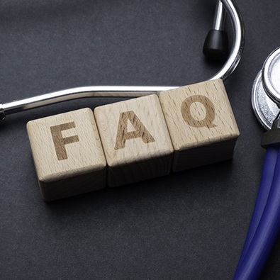 blocks with FAQ surrounded by a stethoscope 
