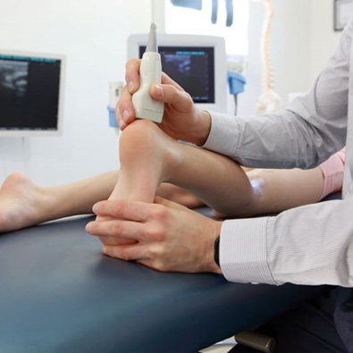 Person undergoing ultrasound scan on foot