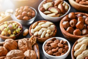 several small bowls filled with nuts 