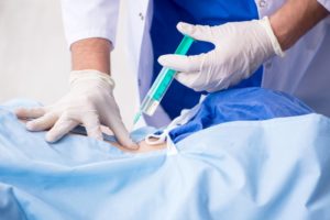 doctor injecting a patient’s knee 